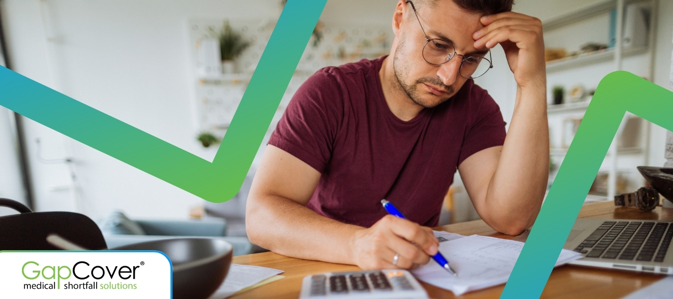 man-reviewing-medical-bills-at-home-gapcover-tariff-shortfall