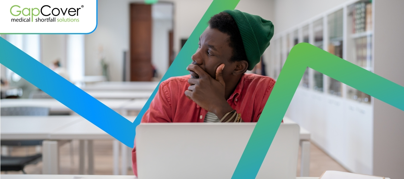 young-man-thinking-while-using-laptop-gapcover-medical-aid-questions